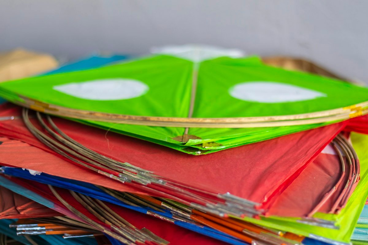 Colorful handcrafted kites stacked together